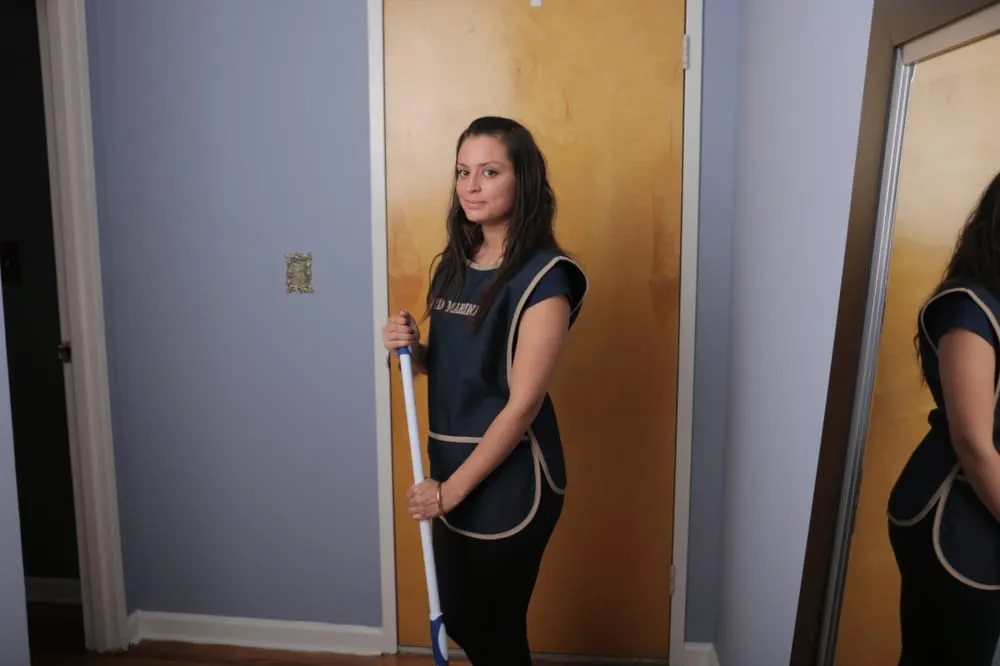 Maid Marines cleaner mopping floors in NYC apartment